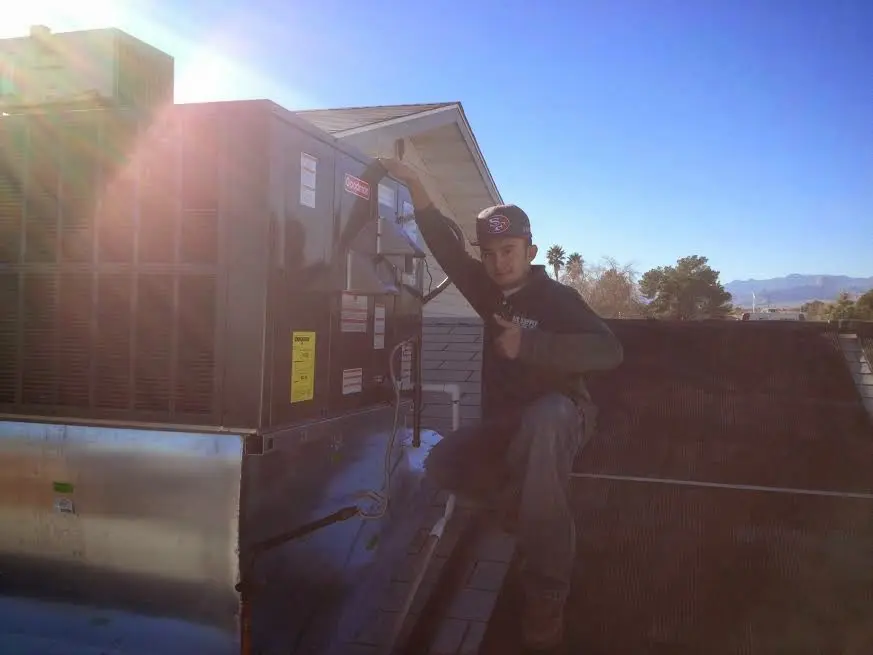HVAC technician performing Boiler Repair on a rooftop unit in Gaithersburg